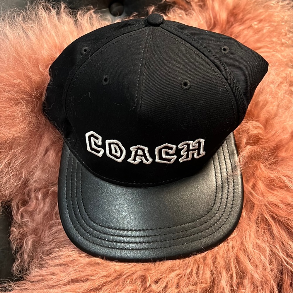 Black coach hat with leather bill.
